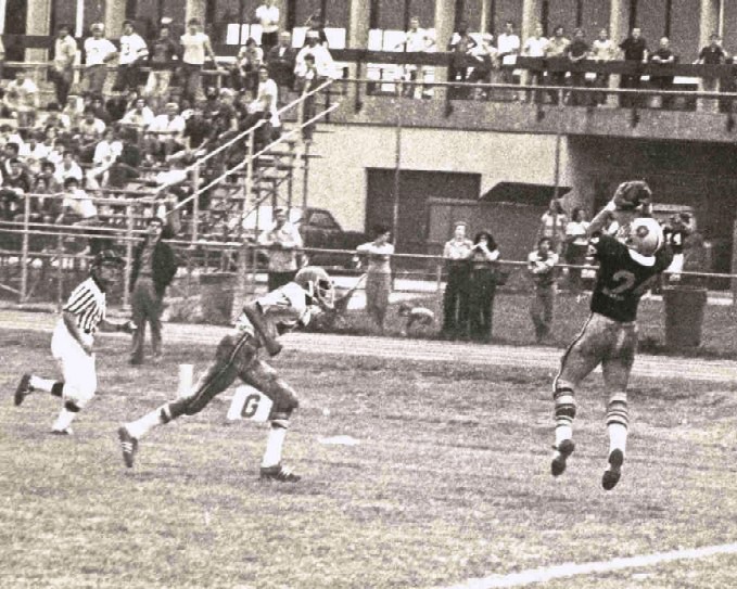 Chuck Margiotta leaping to make a touchdown catch in front of a crowded grandstand
